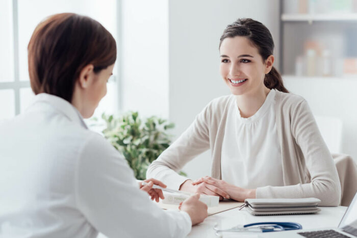 doctor talking with young woman