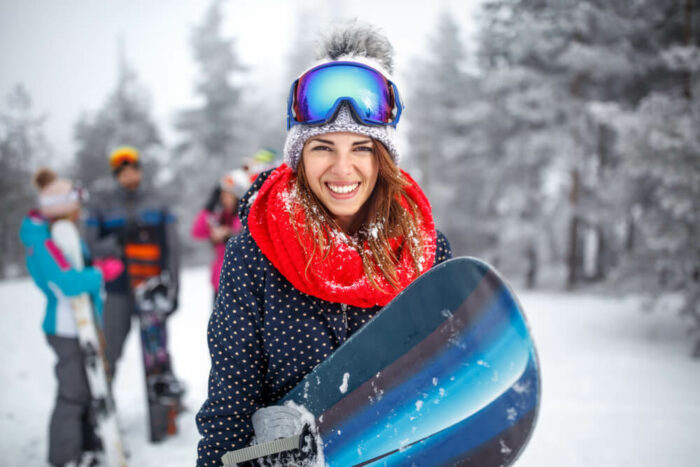 young woman snowboarding