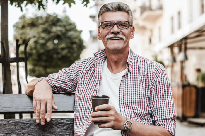 older man with mustache drinking coffee