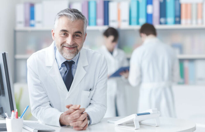 Smiling doctor at desk